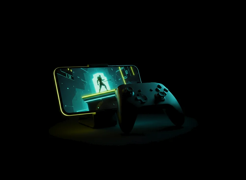 A phone on a stand showing a PC game, next to a wireless controller